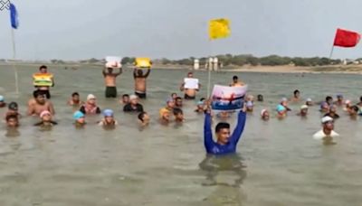 Swimmers perform yoga at Triveni Sangam in Prayagraj ahead of International Yoga Day