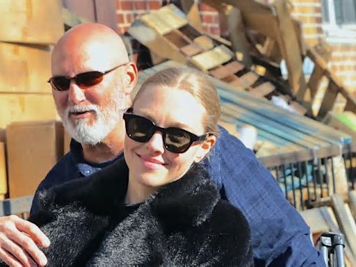 Amanda Seyfried stays warm by layering up in a black fur coat between takes on the New York City set of series Long Bright River