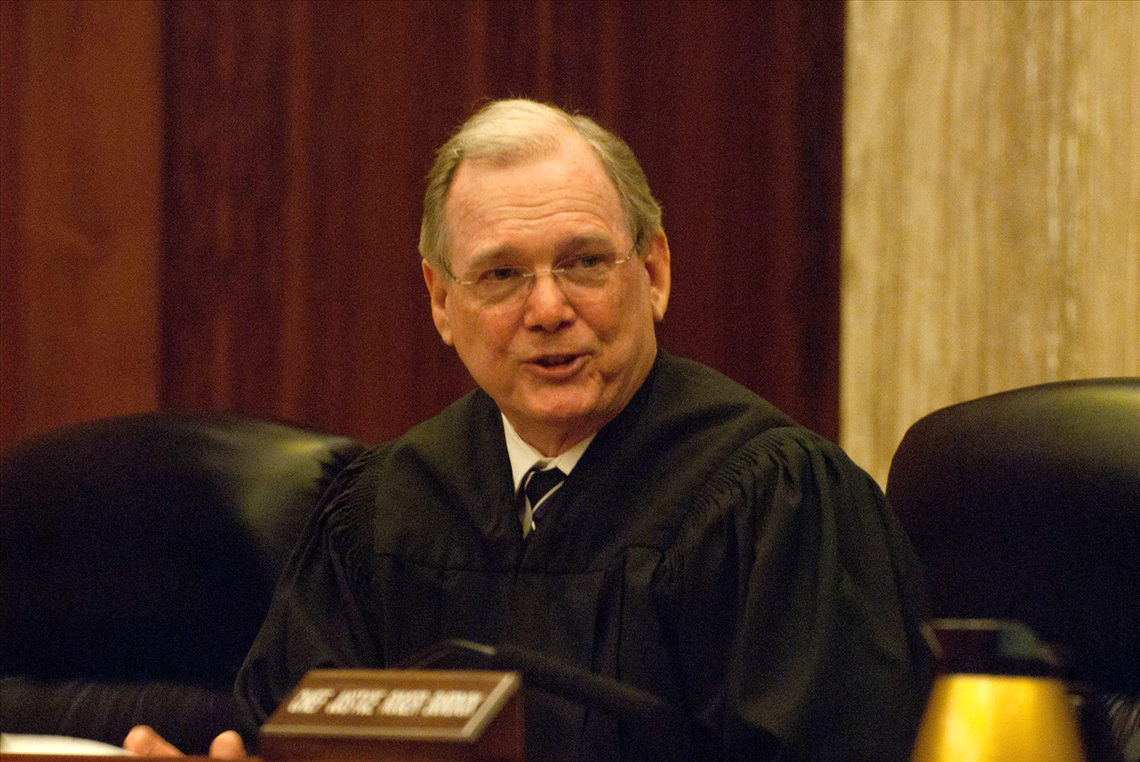 A former Idaho Supreme Court chief justice who was awarded two Purple Hearts has died