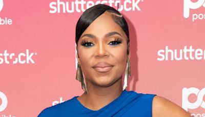 Ashanti, 43, debuts baby bump in blue dress after announcing engagement to Nelly