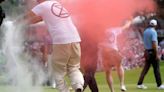 Six intruders run onto 18th green and spray powder, delaying finish of Travelers Championship