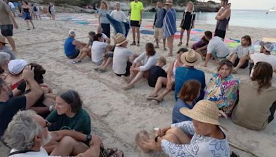 Protesters block beach in Spain spelling out message for tourists in sand