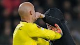 Sevilla goalkeeper Marko Dmitrovic attacked by pitch invader in PSV clash