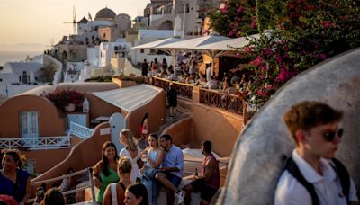 Watch: Santorini’s narrow streets choked by throngs of suitcase-carrying tourists