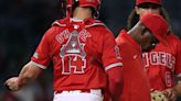 ...infielder Cole Tucker and catcher Logan O'Hoppe, trailing 8-0 to the Kansas City Royals, during the sixth inning at Angel Stadium of Anaheim on Thursday, May...