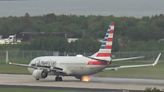 Moment American Airlines Boeing plane's tire explodes during take-off