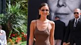 Bella Hadid Makes Cannes Arrival in Brown Corset-stitched Minidress and a Pop of Pink Prada for 2024 Film Festival