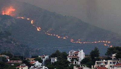 Greece wildfires - latest: One dead and thousands evacuated as flames spread through Athens suburbs