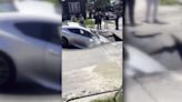 Woman’s car is engulfed by sinkhole after water main leak in SW Detroit