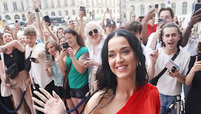 Katy Perry’s Paris Fashion Week Dress Includes an Extra Long Train and the Lyrics to ‘Woman’s World’