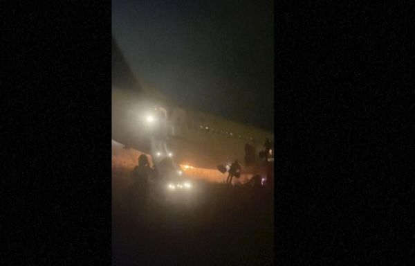 Boeing 737 catches fire and skids off the runway at a Senegal airport. Ten people are injured