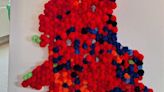 Couple create election map covered in red pom poms after tracking results