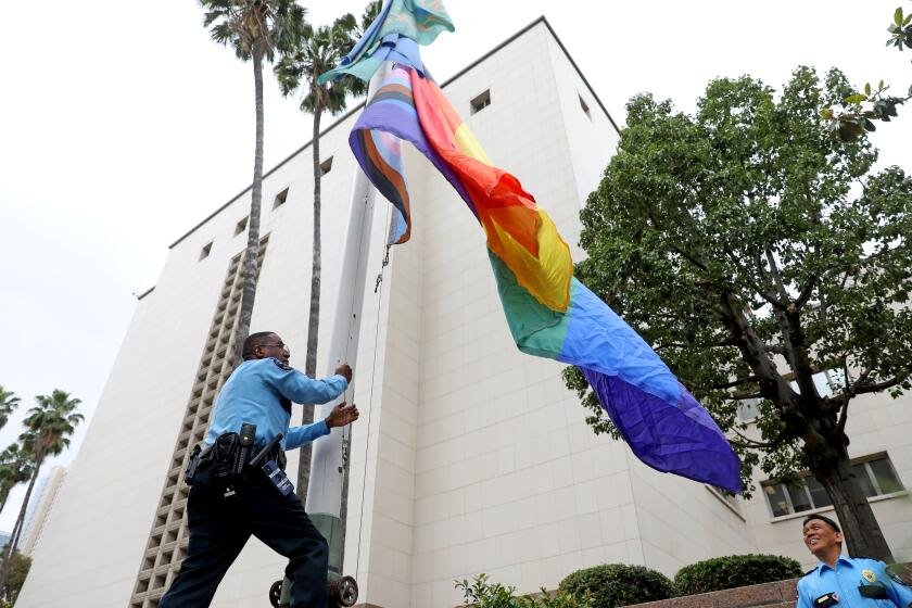 Lifeguard who took down Pride flags at beach sues L.A. County over religious discrimination