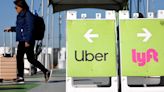 A traveler walks toward the Uber rideshare vehicle pickup area at Los Angeles International Airport on Feb. 8, 2023, in Los Angeles.