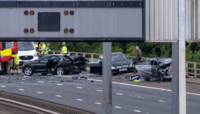 Cop fighting for life after horror three-car M8 smash leaves seven in hospital