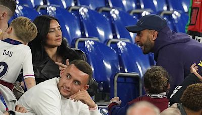 Kyle Walker's wife Annie fails to raise a smile as they reunite after England game – as Lauryn Goodman 'prepares to fly in'