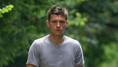 Tom Holland looks casual as he walks his dog in Richmond