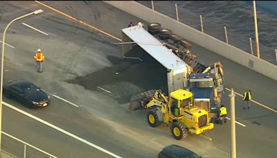 Tractor-trailer carrying gravel overturns creating huge delays on Mario Cuomo Bridge