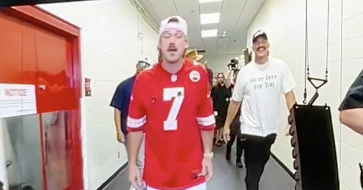 Travis Kelce joins Morgan Wallen onstage while singer wearing Harrison Butker's number