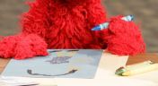 8. Elmo and Alan Play School