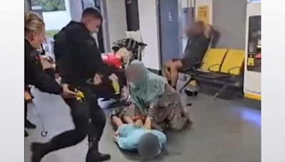 Police watchdog opens criminal investigation into officer filmed kicking man at Manchester Airport