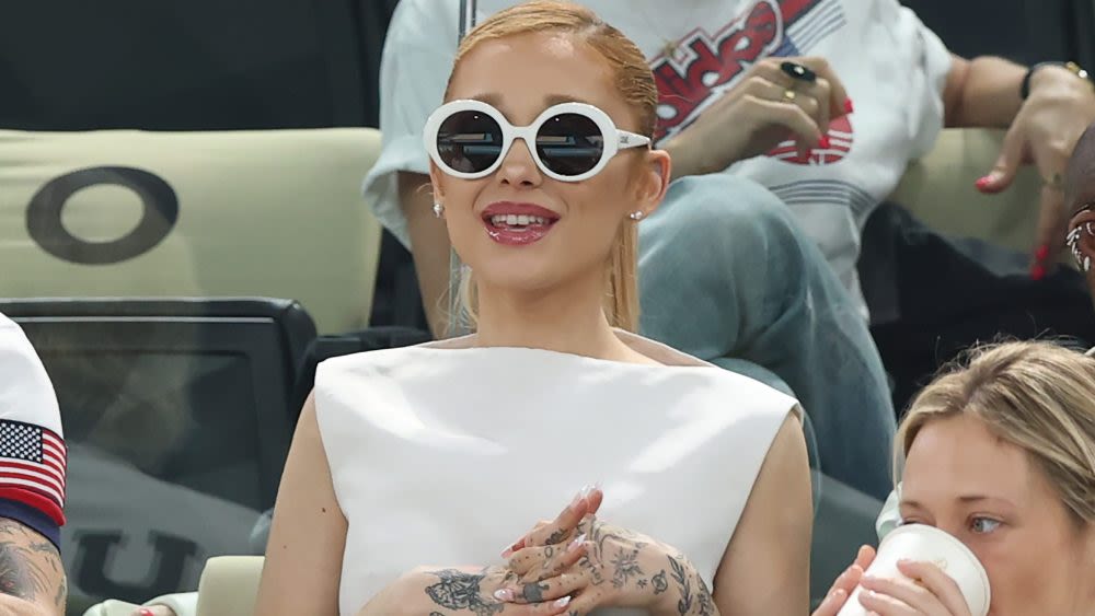 Ariana Grande Embraces 1960s Styling in White Thom Browne Dress and Statement Sunglasses at 2024 Paris Olympics with Cynthia Erivo...