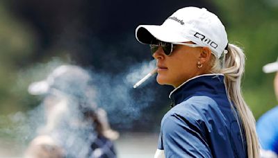 Charley Hull signs a fan's cigarette after smoking on the golf course