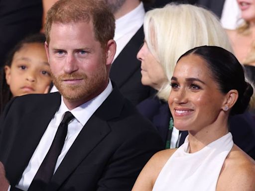 Meghan exudes easy elegance in a white halterneck gown for surprise red-carpet appearance