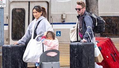 Macaulay Culkin and Brenda Song get caught in the rain while hopping off the train with their kids in LA