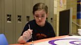 Looking up: Families paint ceiling tiles at Galion Middle School