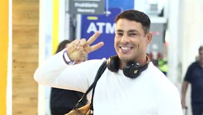 Cauã Reymond distribui sorrisos ao desembarcar no Rio