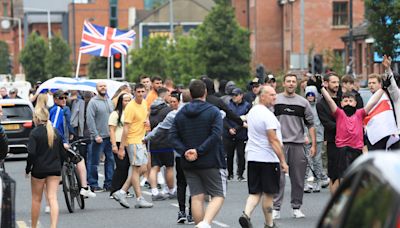 Police attacked in Belfast and suspected hate crime victim in serious condition