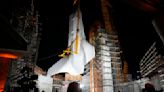 Space shuttle Endeavour hoisted for display in launch configuration at Los Angeles science museum