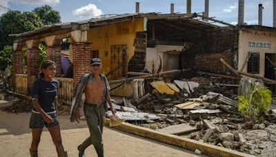 Along Mexico's Pacific coast, flooding from Hurricane John left devastated towns and 15 dead