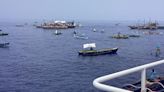 Filipino activists and fishermen sail in 100-boat flotilla to disputed shoal guarded by China