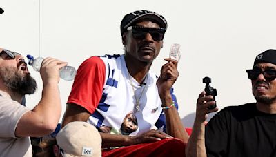 Snoop Dogg Wears Custom T-Shirts Featuring Olympians Simone Biles And Coco Gauff Amid Paris Olympics 2024 Appearance