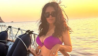 Salma Hayek, 57, is a busty beauty in a purple bikini top