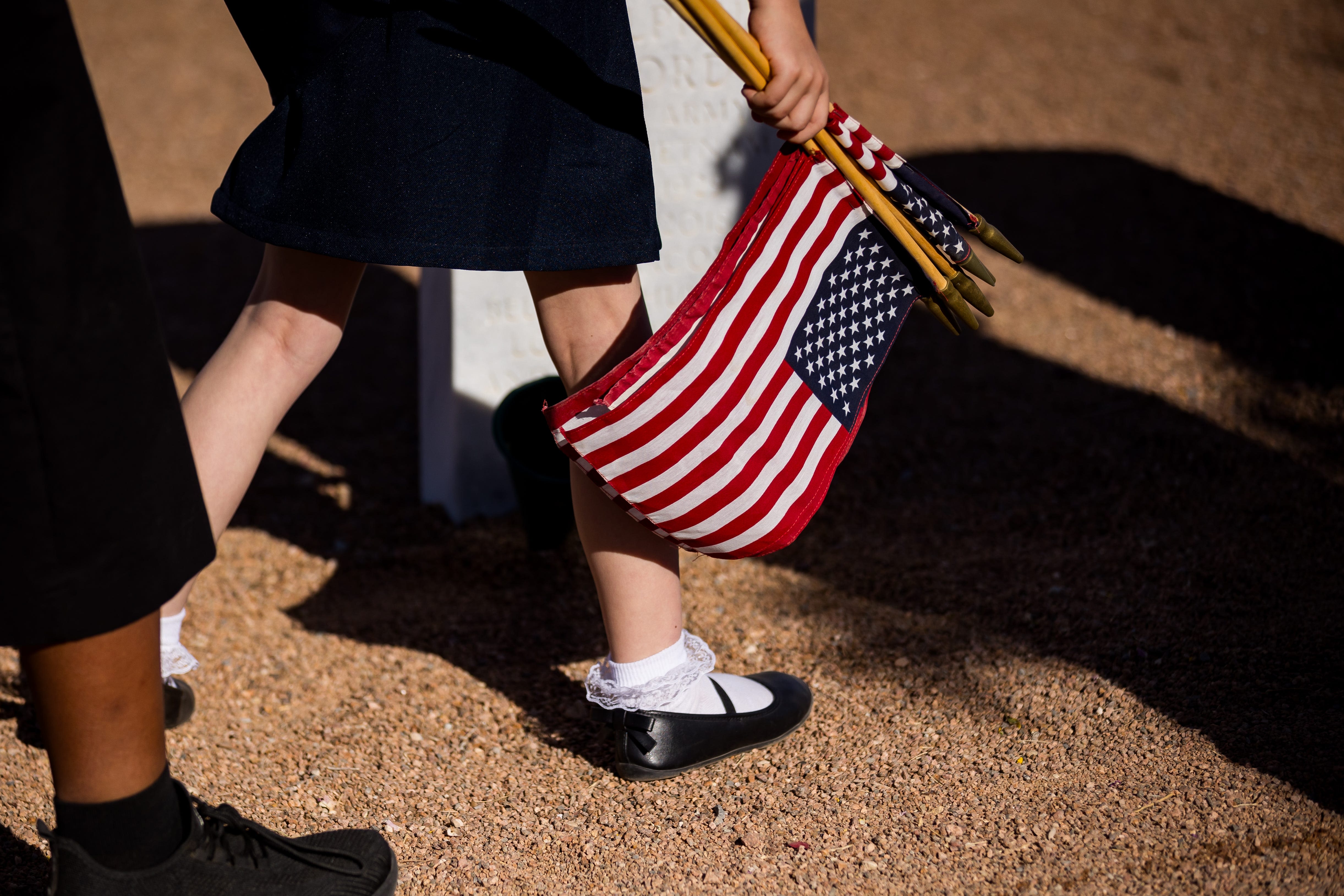 Girl Scout troops and Scouts of America placed American flags at Fort Bliss Cemetery Saturday