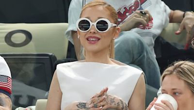 Ariana Grande Embraces 1960s Styling in White Boatneck Dress and Statement Sunglasses at 2024 Paris Olympics with Cynthia Erivo and Baz Luhrmann