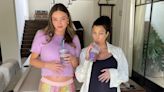 Pregnant Kourtney Kardashian & Miranda Kerr Cradle Their Baby Bellies In Cute New Photo