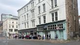 Excited music fans queue outside Glasgow store to meet famous rock duo