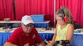 Children learn hands-on about aviation careers - including a B-25 'flight' - at EAA's AirVenture