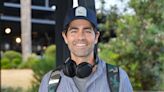 Adrian Grenier is all smiles as he touches down in Sydney