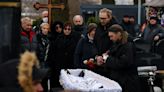 Navalny's parents bury their son as thousands chant his name