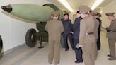 North Korea unveils new nuclear warheads as US air carrier arrives in South