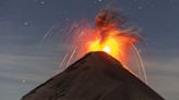 Moment lightning strikes erupting volcano as it spews ash and lava into the air