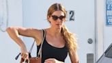 Gisele Bundchen wears skintight black leggings and matching tank top