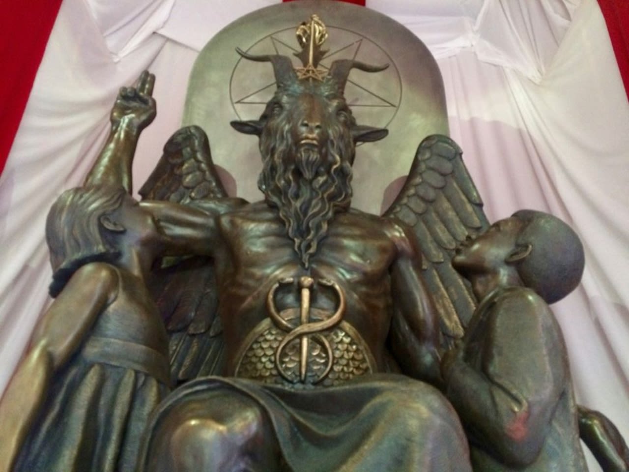 Man traveled with guns and homemade ‘bombs' to the Satanic Temple, officials say