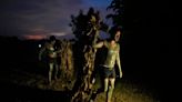 AP PHOTOS: Philippine villagers smear mud on their bodies to show devotion to St. John the Baptist