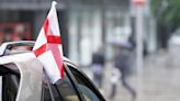 Flags attached to cars are not allowed to obstruct the driver’s vision